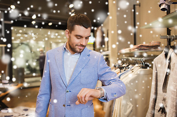 Image showing happy man in jacket with watch at clothing store