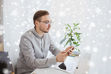 Image showing creative male office worker texting on smarphone