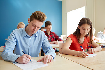 Image showing group of students with books writing school test