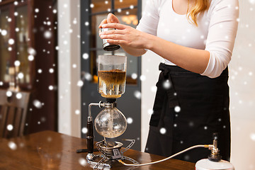 Image showing close up of woman with siphon coffee maker and pot