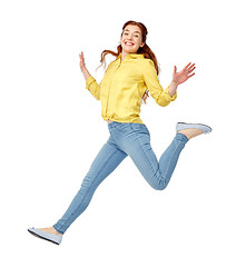 Image showing smiling young woman jumping in air