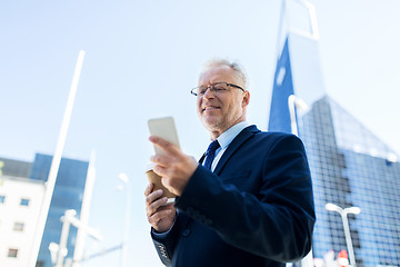 Image showing businessman with smartphone and coffee in city