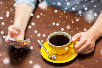 Image showing woman with smartphone drinking coffee at cafe