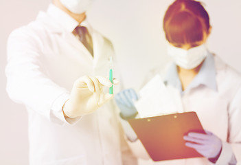 Image showing doctors with syringe