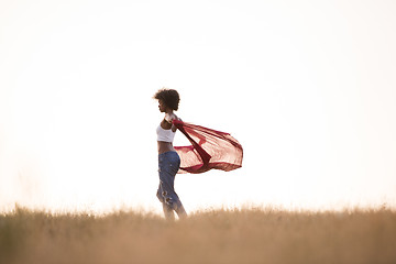 Image showing black girl dances outdoors in a meadow