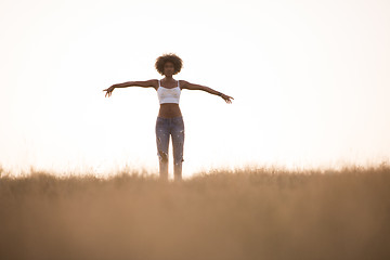 Image showing young black girl dances outdoors in a meadow