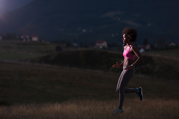 Image showing Young African american woman jogging in nature