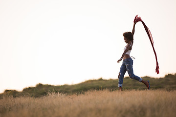 Image showing black girl dances outdoors in a meadow