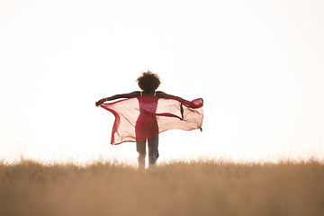 Image showing black girl dances outdoors in a meadow