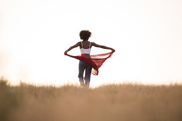 Image showing black girl dances outdoors in a meadow