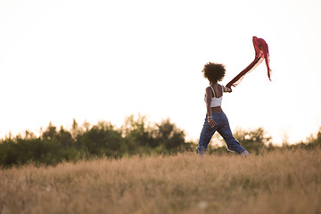 Image showing black girl dances outdoors in a meadow