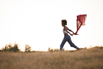 Image showing black girl dances outdoors in a meadow