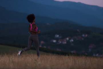 Image showing Young African american woman jogging in nature