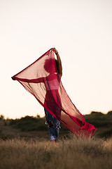 Image showing black girl dances outdoors in a meadow