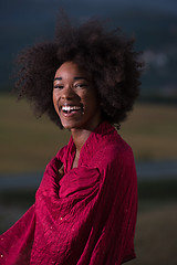 Image showing outdoor portrait of a black woman with a scarf