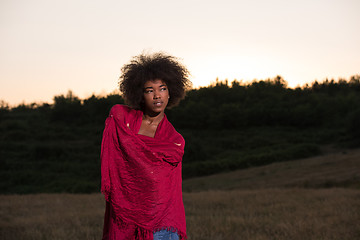 Image showing outdoor portrait of a black woman with a scarf