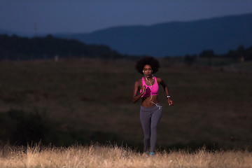 Image showing Young African american woman jogging in nature