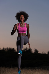 Image showing black woman is doing stretching exercise relaxing and warm up