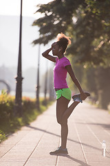 Image showing Black woman doing warming up and stretching