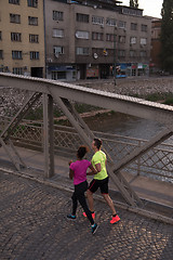 Image showing young multiethnic couple jogging in the city