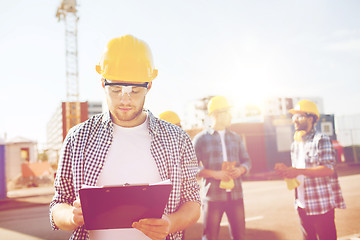 Image showing group of builders in hardhats outdoors