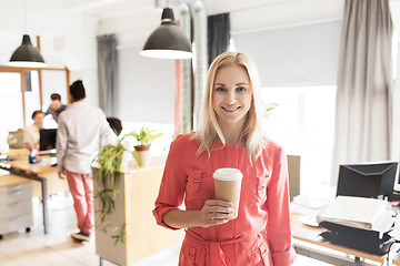 Image showing happy creative woman with coffee cup at office