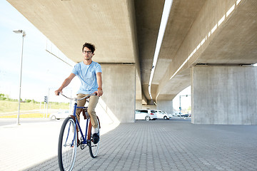 Image showing young hipster man riding fixed gear bike