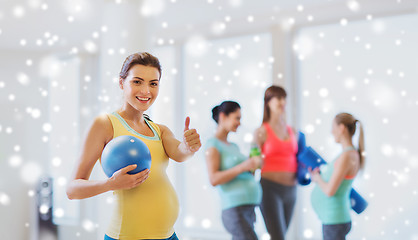 Image showing pregnant woman with ball in gym showing thumbs up