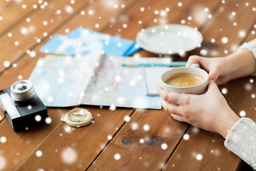 Image showing hands with coffee cup and travel stuff