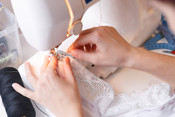 Image showing Woman doing lines on sewing-machine