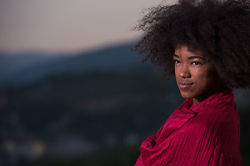 Image showing outdoor portrait of a black woman with a scarf