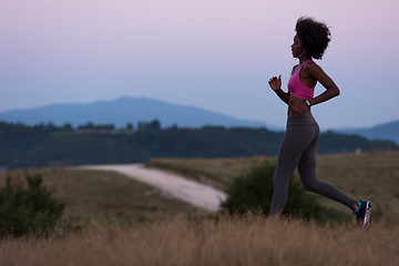 Image showing Young African american woman jogging in nature