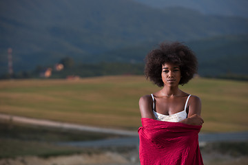 Image showing outdoor portrait of a black woman with a scarf