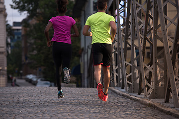 Image showing multiethnic couple jogging in the city