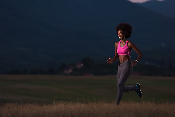 Image showing Young African american woman jogging in nature