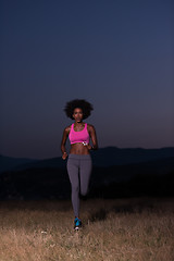 Image showing Young African american woman jogging in nature