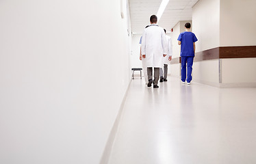 Image showing group of medics or doctors walking along hospital