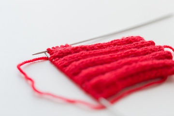 Image showing hand-knitted item with knitting needles