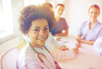 Image showing happy doctor over group of medics at hospital