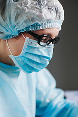 Image showing Crop hands putting microscope glasses in box