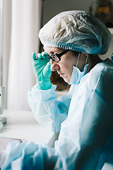 Image showing Side view of scientist working on tablet