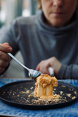 Image showing woman breaks off a piece of dessert