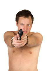 Image showing The guy chained in handcuffs with revolver. isolated