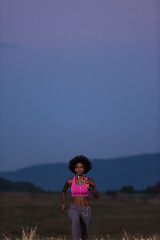 Image showing Young African american woman jogging in nature