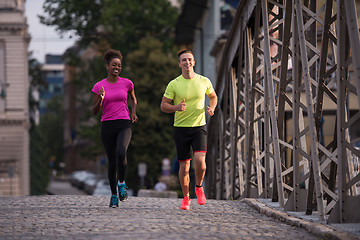 Image showing multiethnic couple jogging in the city