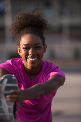 Image showing African American woman doing warming up and stretching