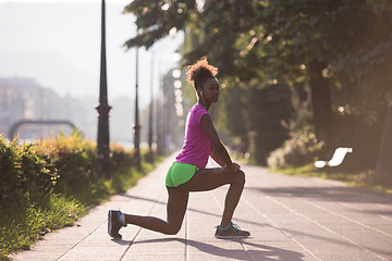 Image showing Black woman doing warming up and stretching