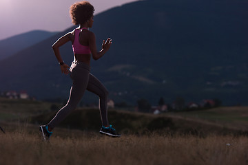 Image showing Young African american woman jogging in nature