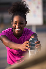 Image showing African American woman doing warming up and stretching