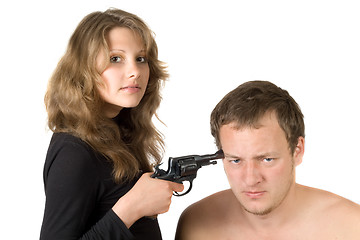 Image showing The girl threatens the young man with a pistol. Isolated